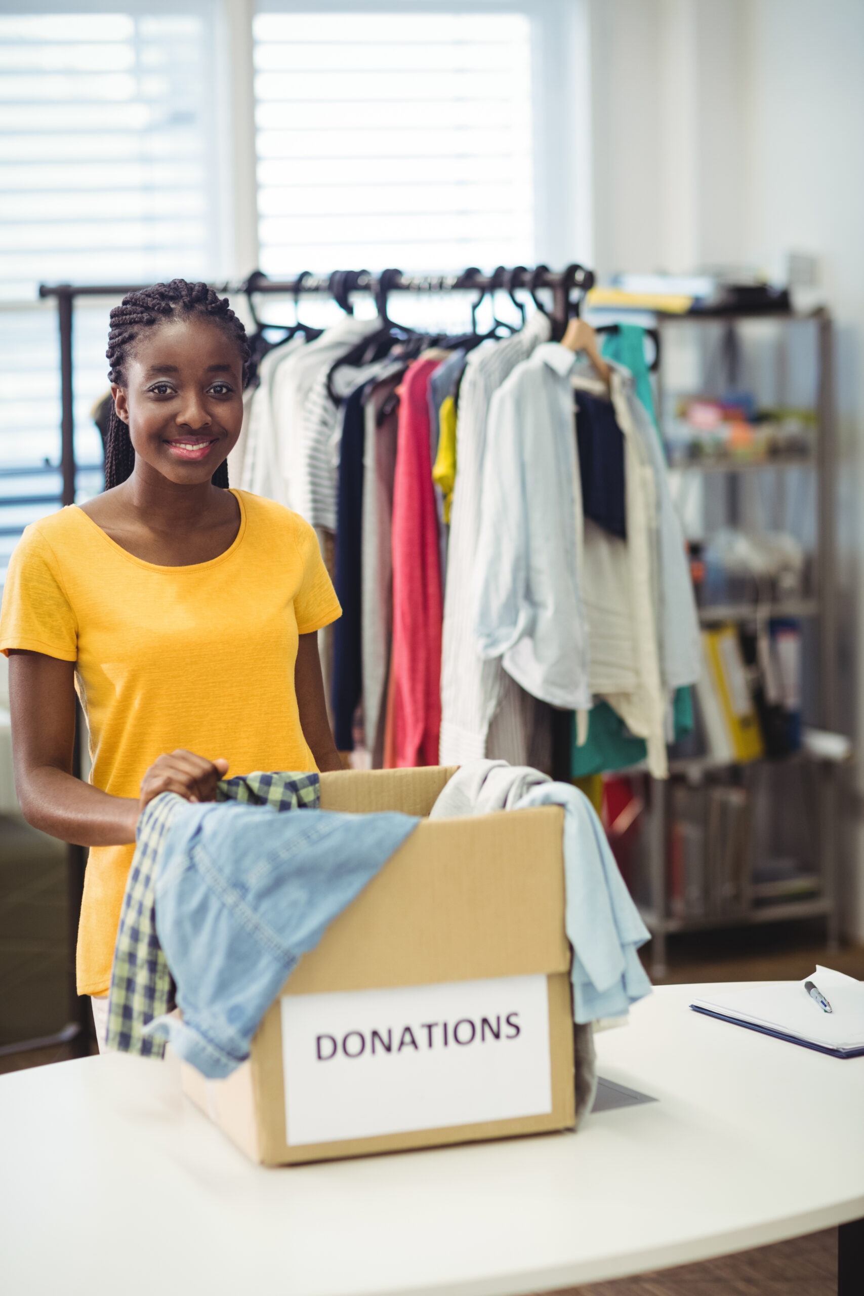 female volunteer standing with donation box
